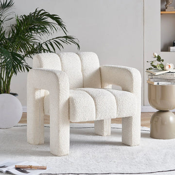 Modern white armchair in a stylish living room with decor elements.