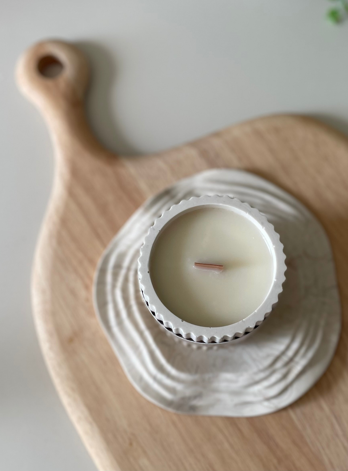 Candle in a decorative holder on a wooden surface