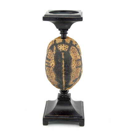 Decorative candle holder with textured base and black pedestal on a white background