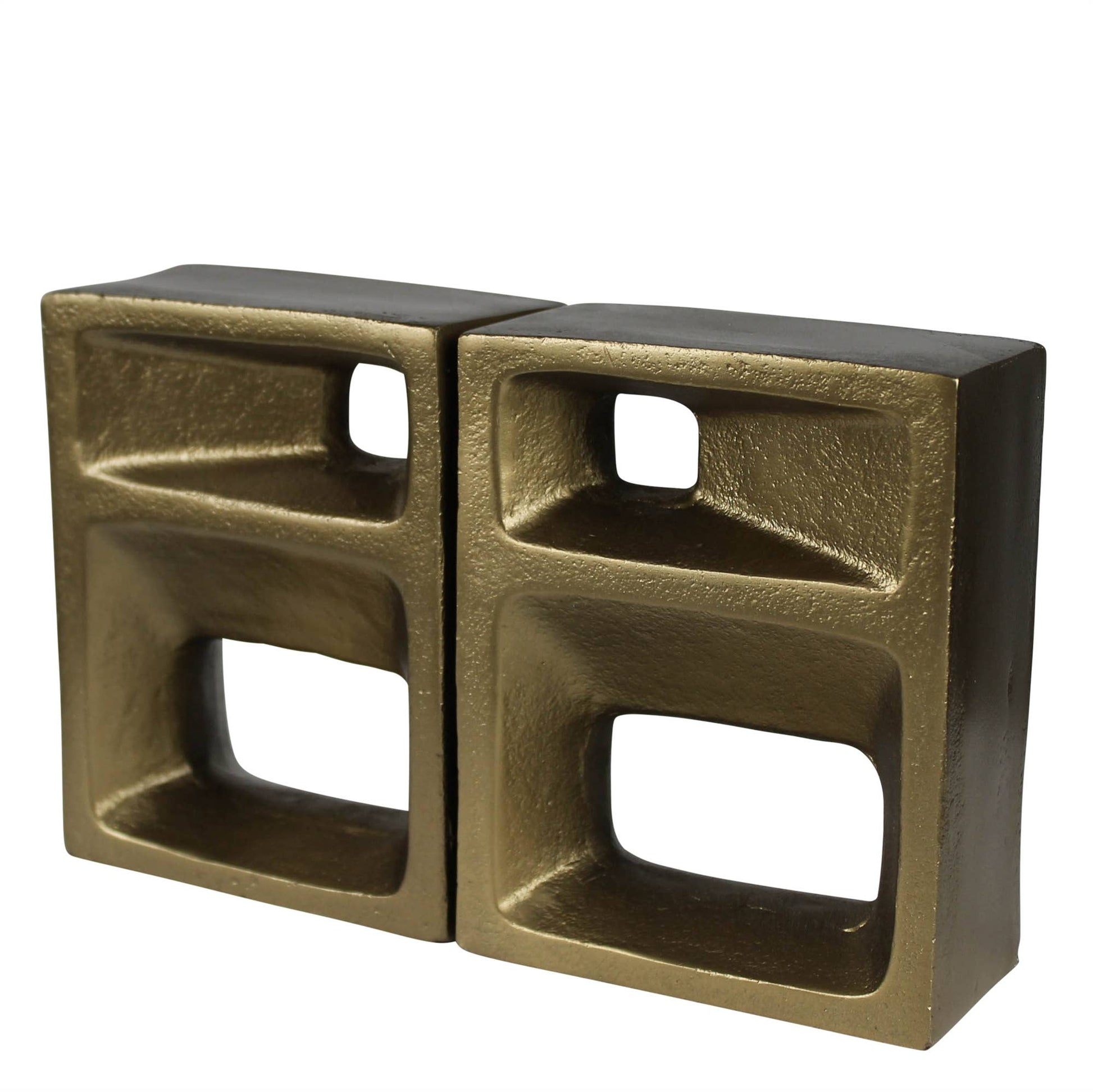 Bronze-colored metal block with geometric design on a white background