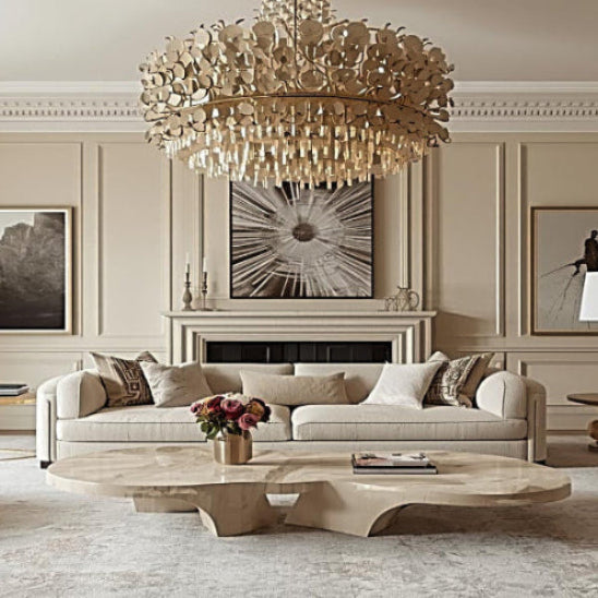 Luxurious living room with a chandelier, sofa, and coffee table.
