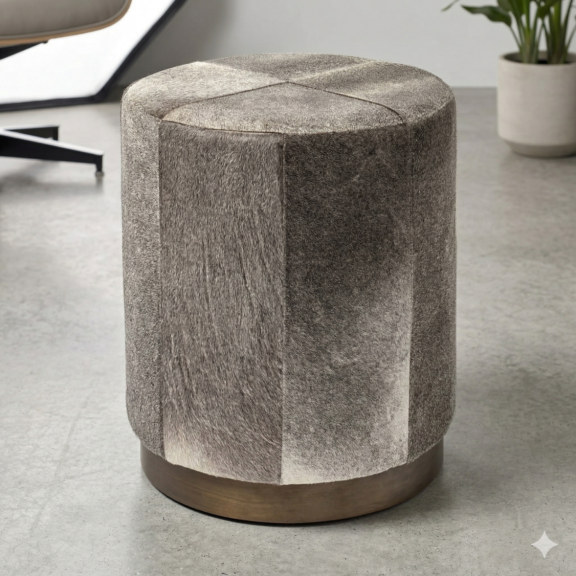 Textured cylindrical stool on a gray floor with a blurred background