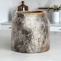 Vintage-style ceramic jar on a kitchen counter with blurred background