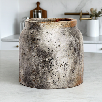 Vintage-style ceramic jar on a kitchen counter with blurred background