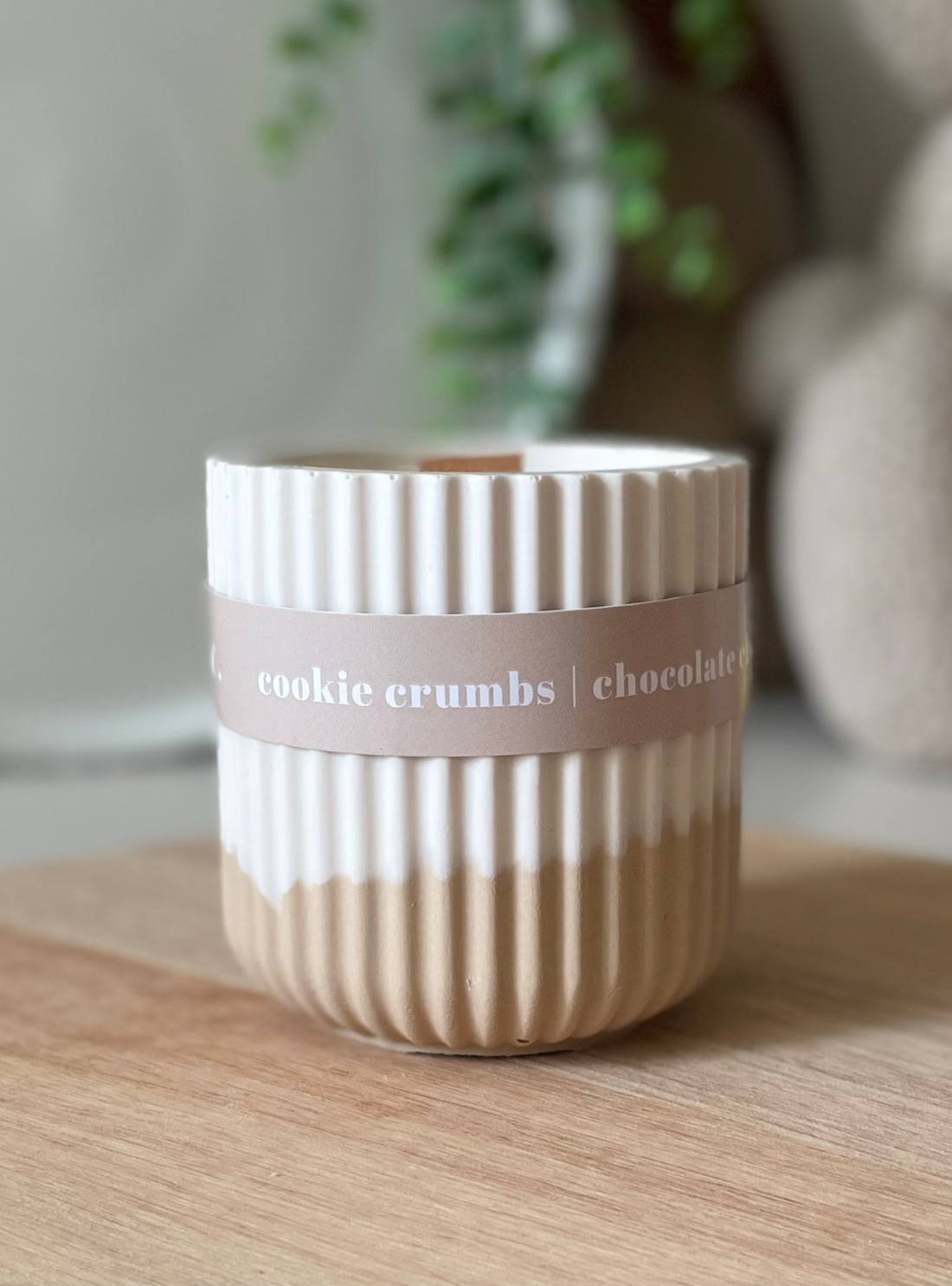 Striped ceramic container with 'cookie crumbs chocolate' label on a wooden surface
