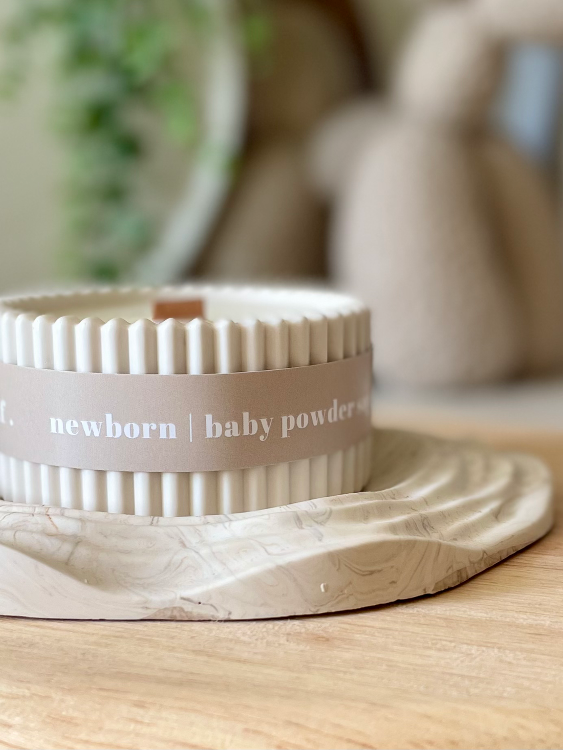 Jar of baby powder with a decorative lid on a wooden surface