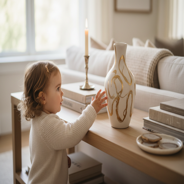 child touching table decor vase